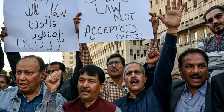 Members of the Pakistan Federal Union of Journalists shout slogans during a protest against amendments in the Prevention of Electronic Crimes Act (PECA) in Karachi on January 28, 2025. Pakistan criminalised online disinformation on January 28, passing legislation that enshrines punishments of up to three years in prison, a decision journalists say is designed to crack down on dissent. (Photo by Asif HASSAN / AFP)
